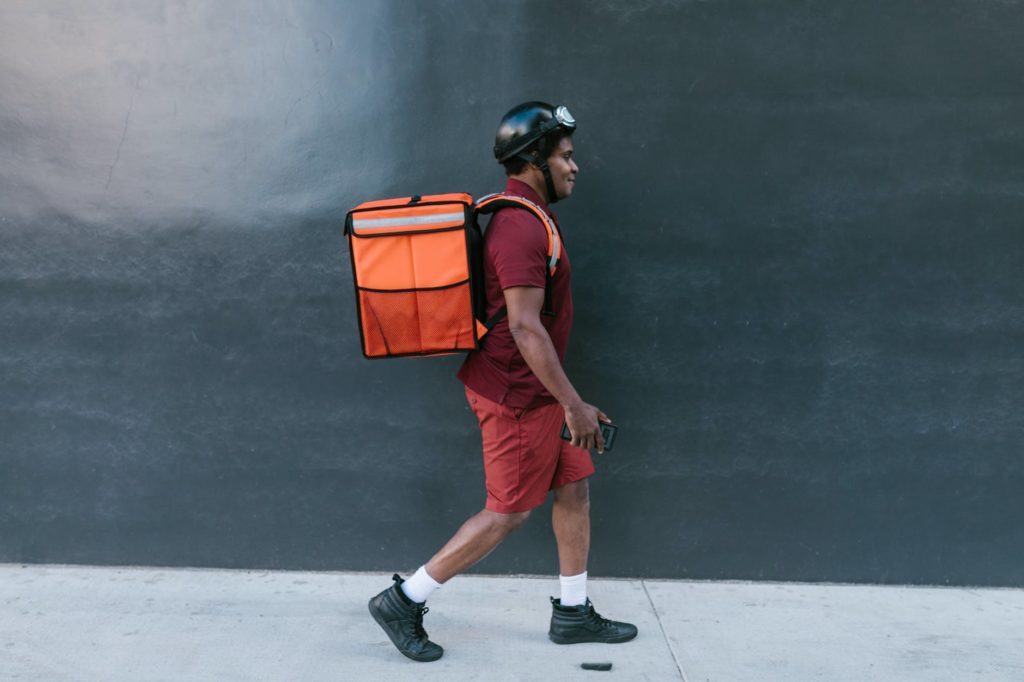 A Doordash delivery guy walking down the street