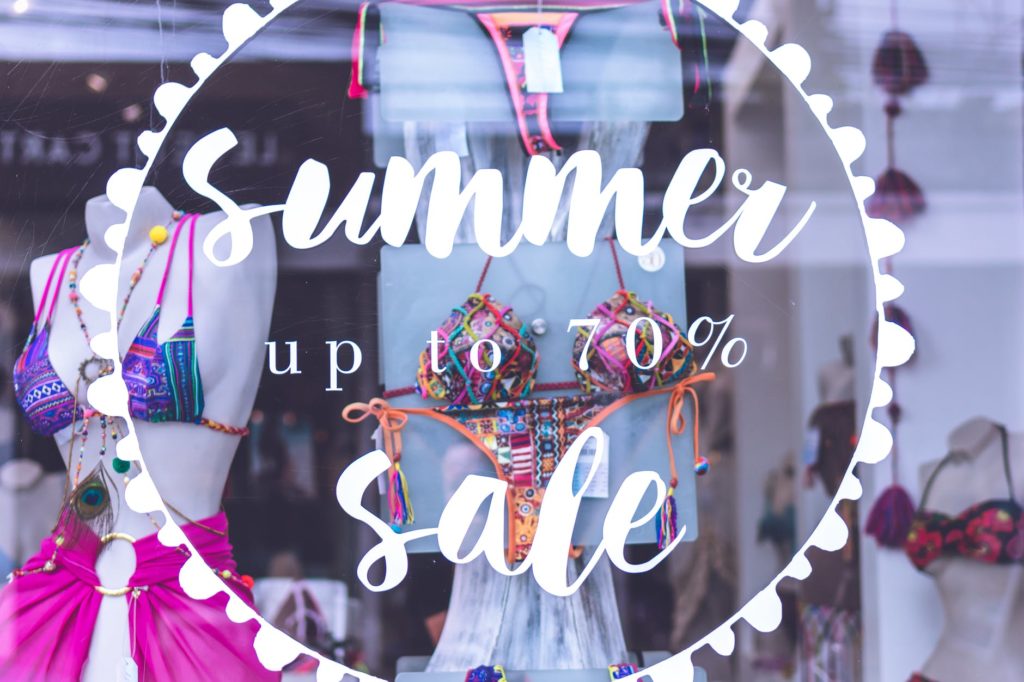 a summer sale up to 70 picture on a store window