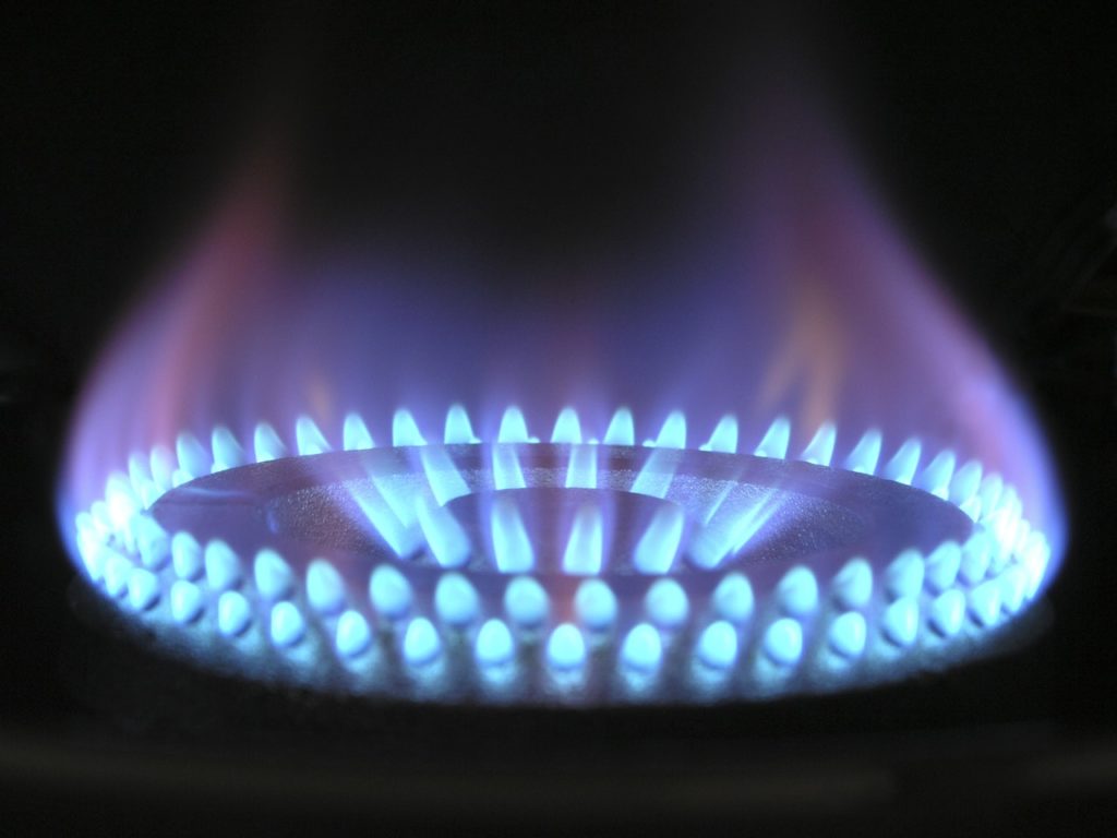 an unattended burner with blue hot flame which is an accident waiting to happen